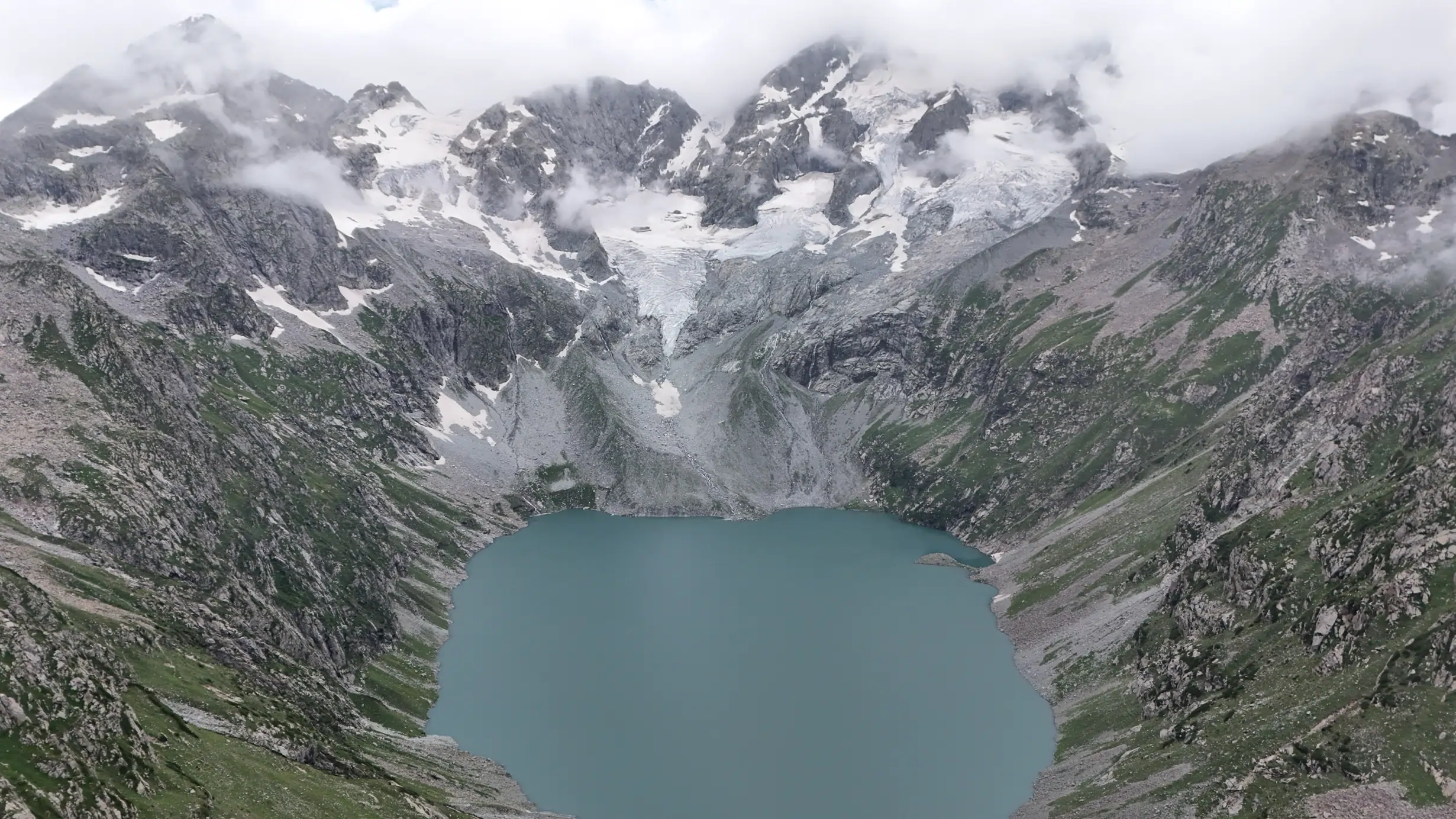 Aerial view of Katora Lake surrounded by mountain peaks